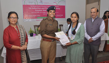 Girl receiving cheque at Greater Noida
